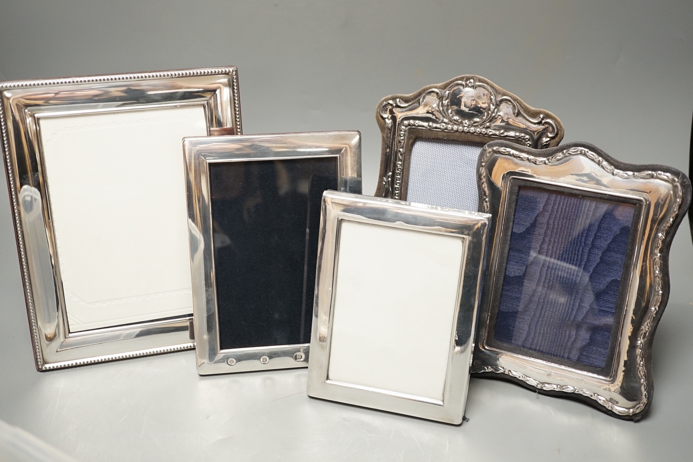 Four assorted modern silver mounted photograph frames, largest 22.2cm and an E.P.N.S. mounted photograph frame.